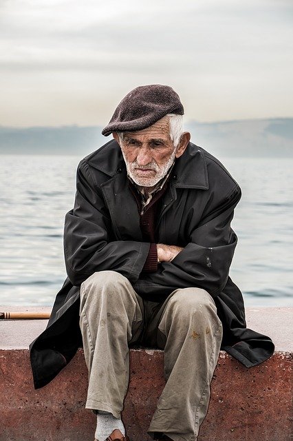 Image of old lonely man to support the text, loneliness can  lead to depression from social isolation, and increasing risk of developing dementia, however social interaction  may reduce the risk of dementia, and may also slow down its progress